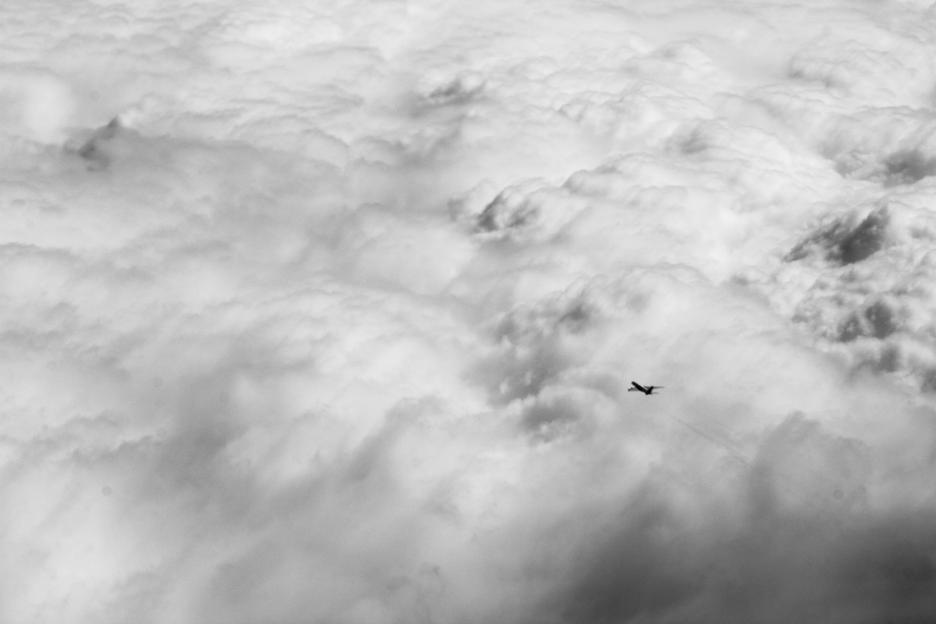 Aereo di linea vola sopra una coltre di nubi